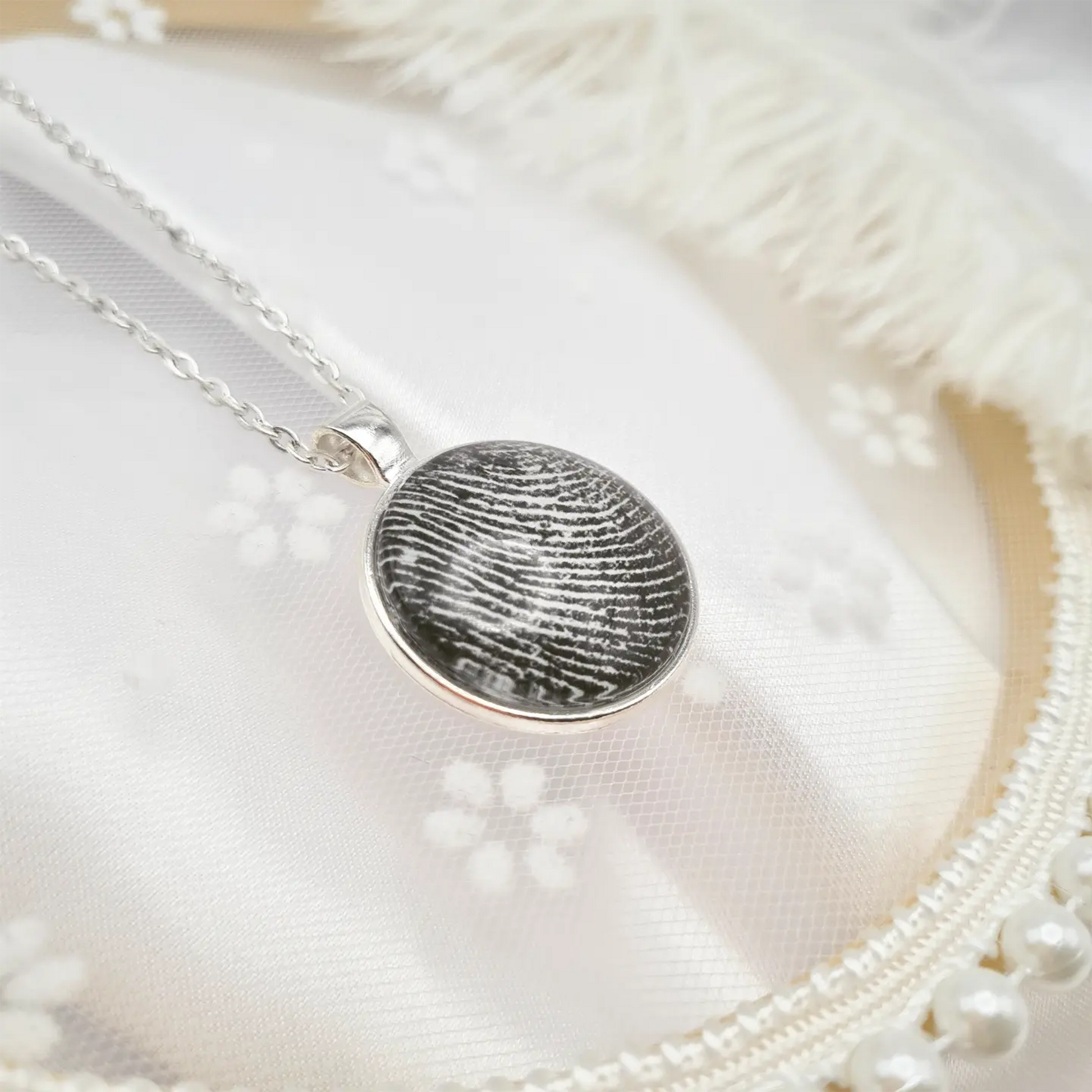 Silver necklace with pendant with a personalised fingerprint set in glass