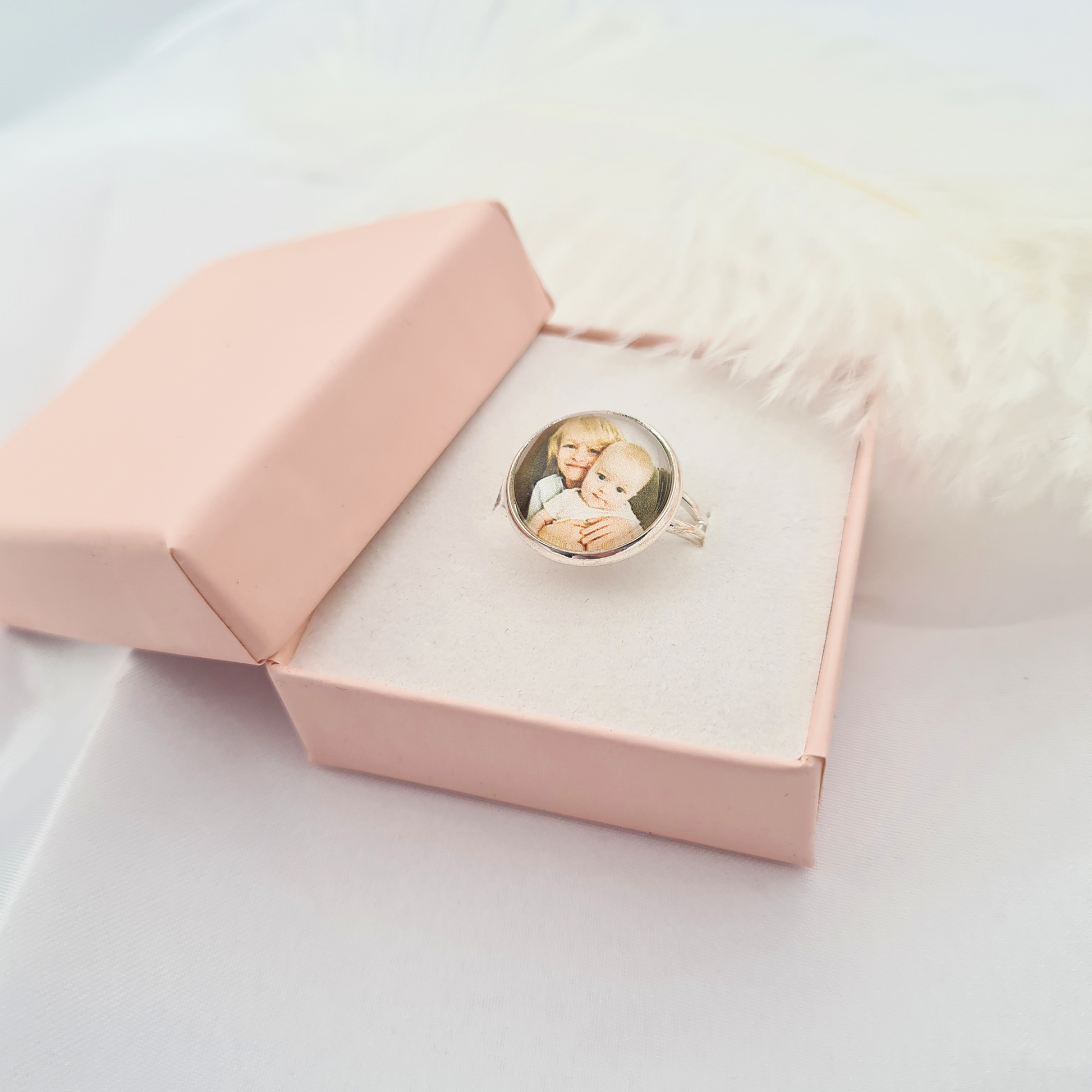 Silver ring personalised with a photo set in glass inside a pink box