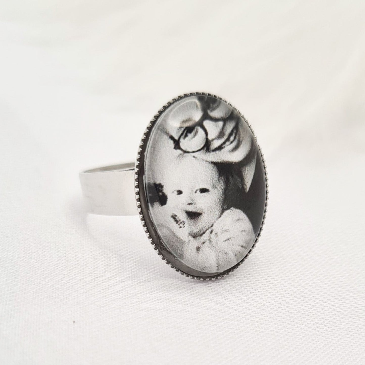 Silver oval ring personalised with a photo set in glass