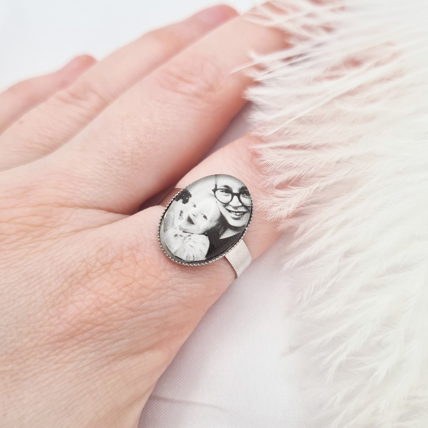 Silver oval ring personalised with a photo set in glass on a finger