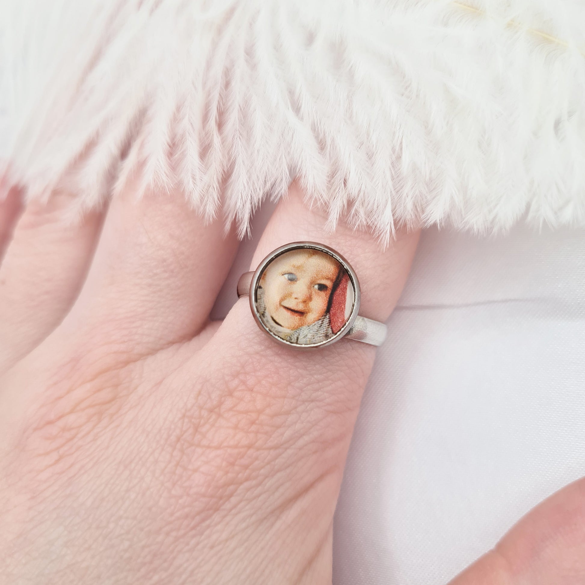 Stainless steel ring personalised with a photo set in glass worn on finger