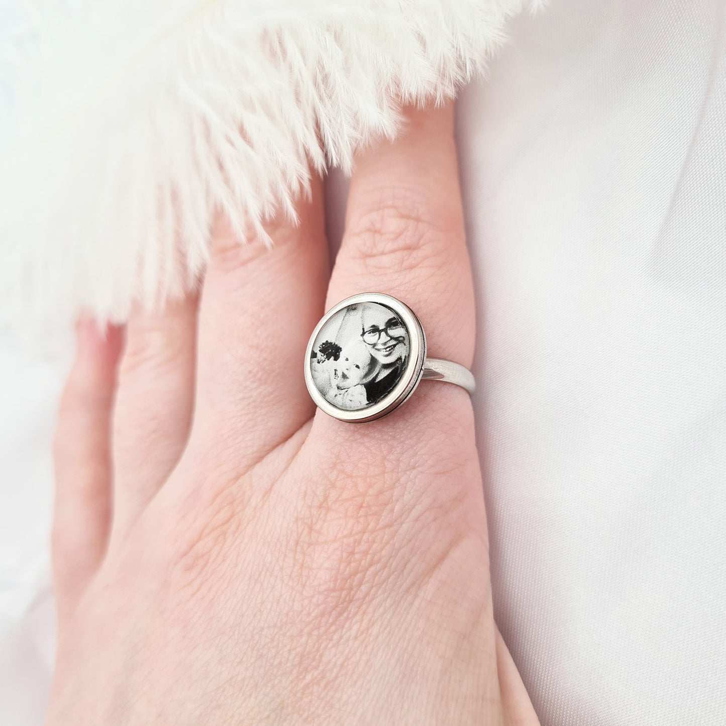 Stainless steel ring with personalised photo set in glass worn on finger