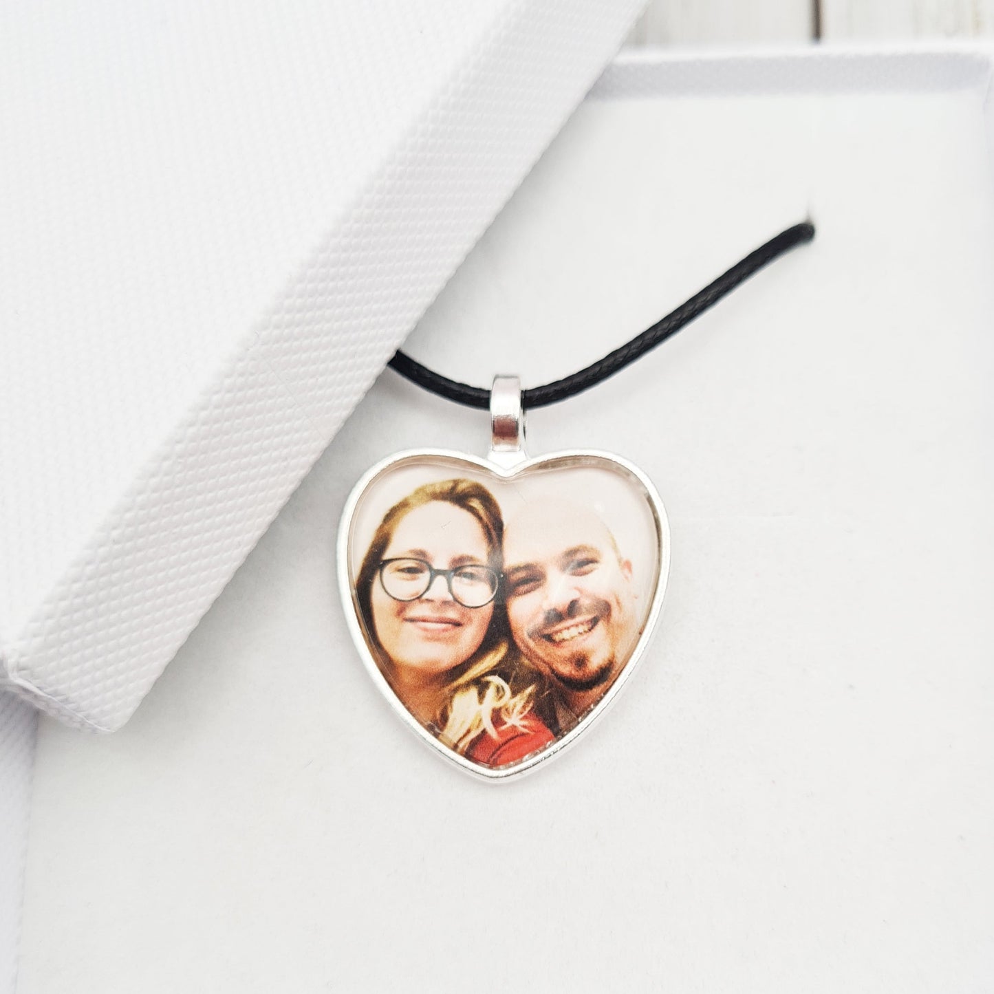 Silver heart shaped pendant with wax cord with a personalised photo set in glass inside a white box