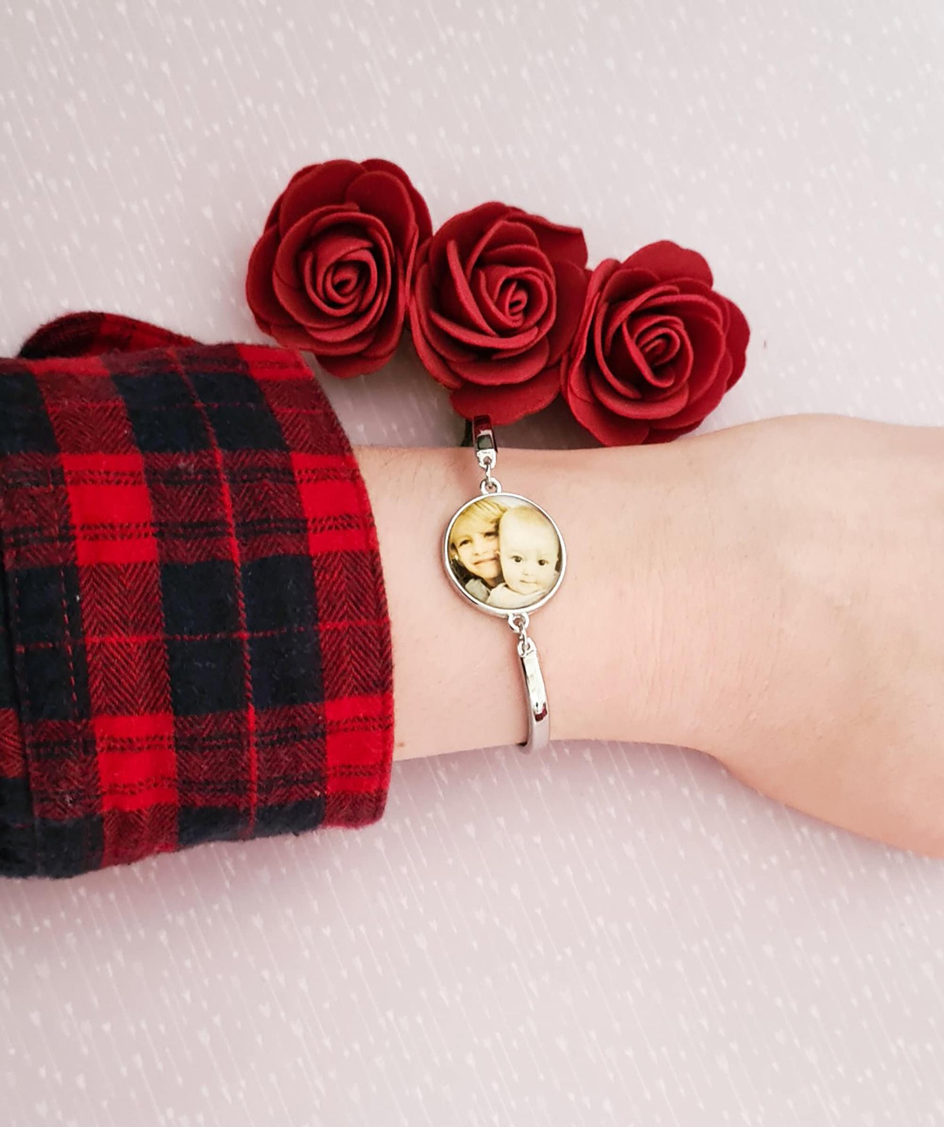 Silver bracelet with personalised photo set in glass worn on wrist