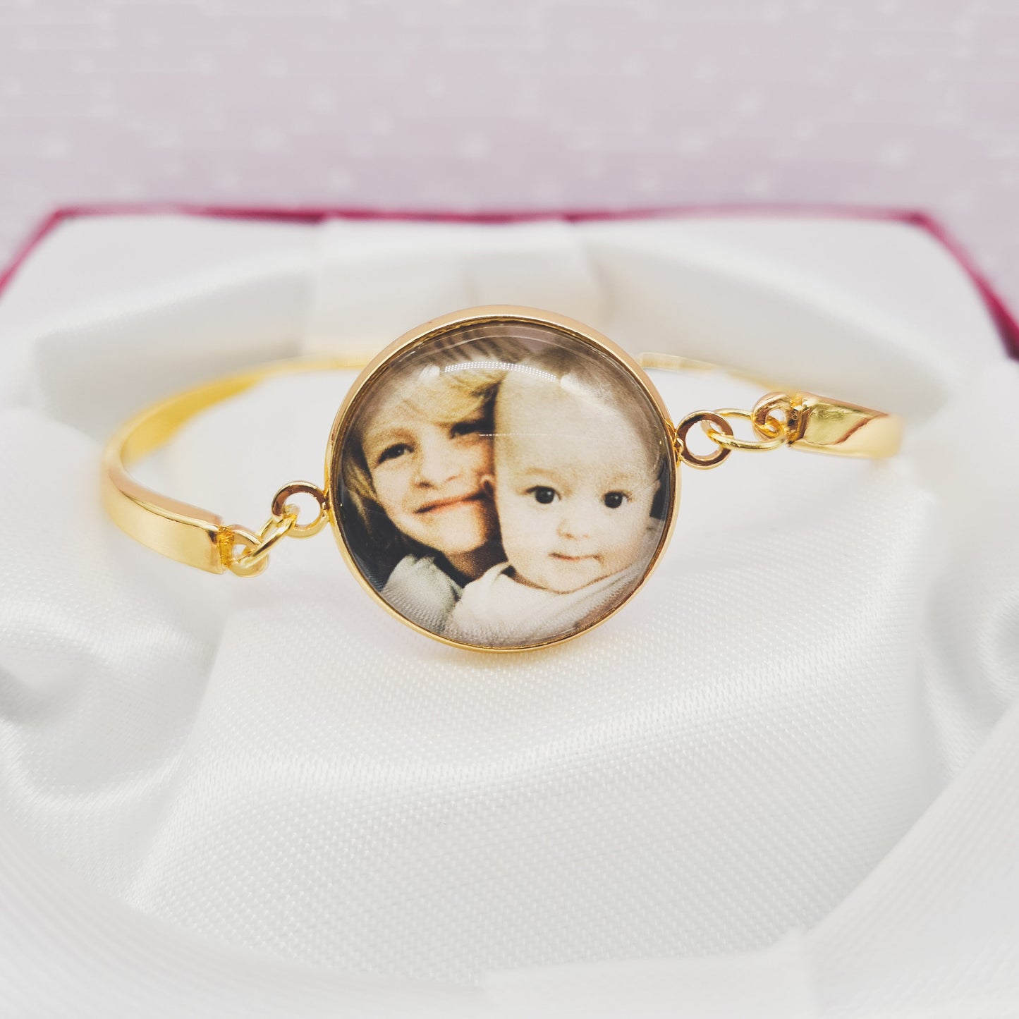 Gold bracelet personalised with a photo set in glass in a red gift box