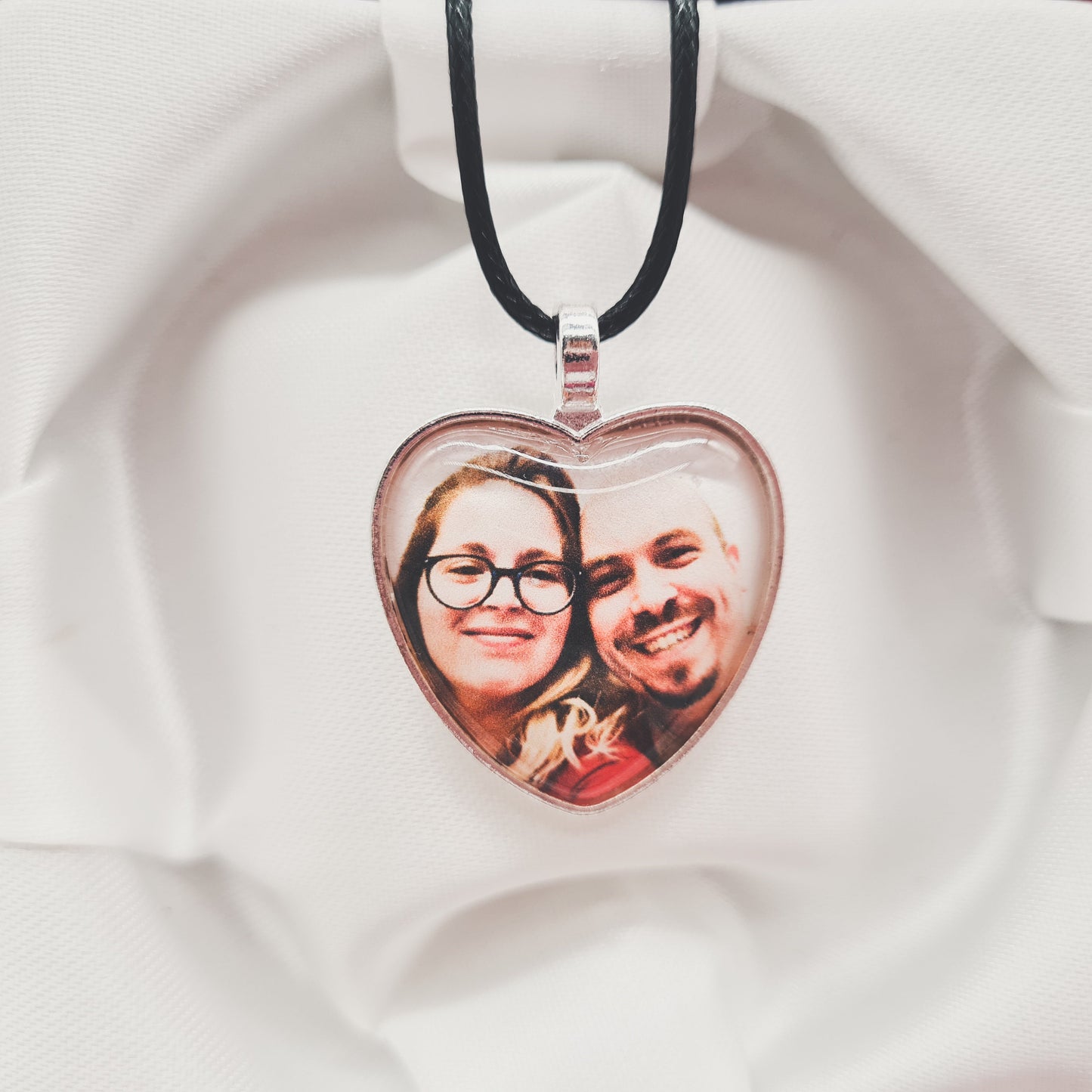 Silver heart shaped pendant with wax cord with a personalised photo set in glass inside a white box