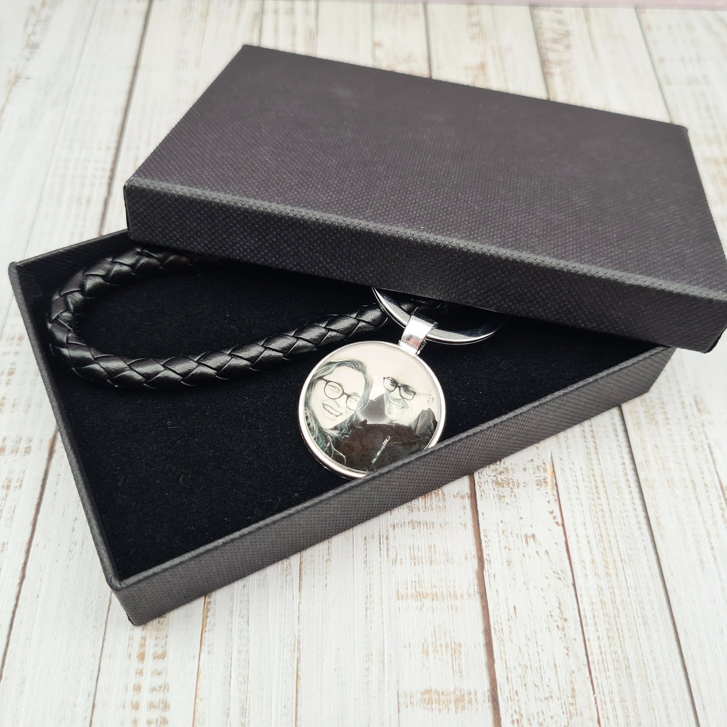 Black leather keyring with silver pendant and a personalised photo in glass inside a black box