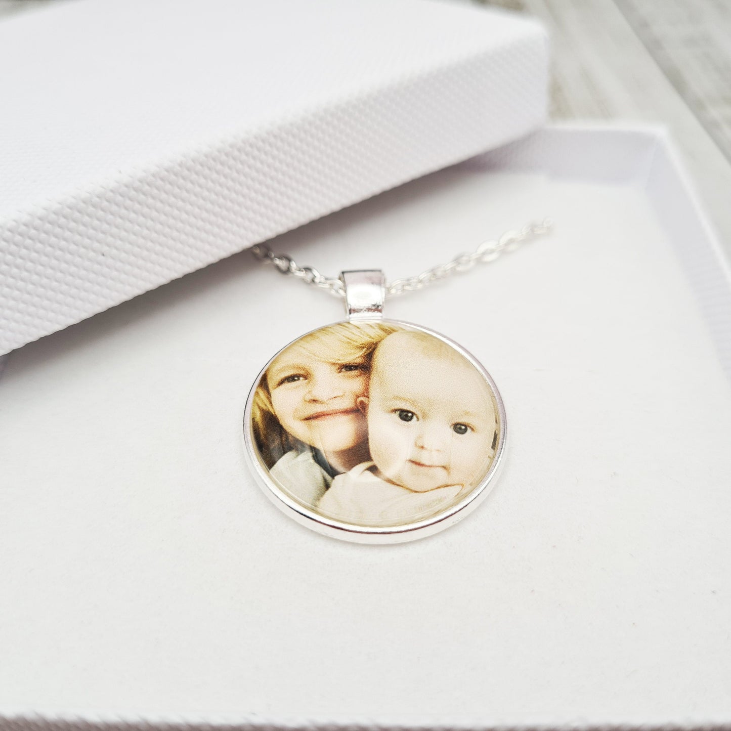 Silver necklace and pendant with personalised photo set in glass inside a white gift box