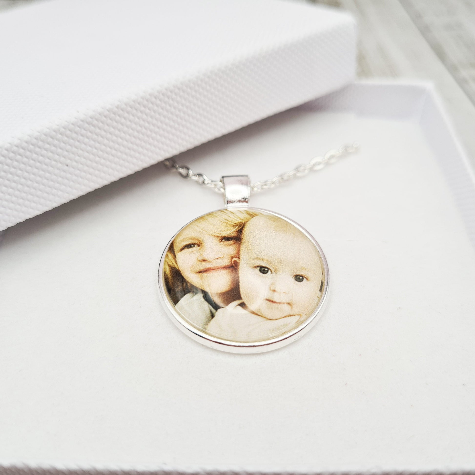 Silver necklace and pendant with personalised photo set in glass inside a white gift box