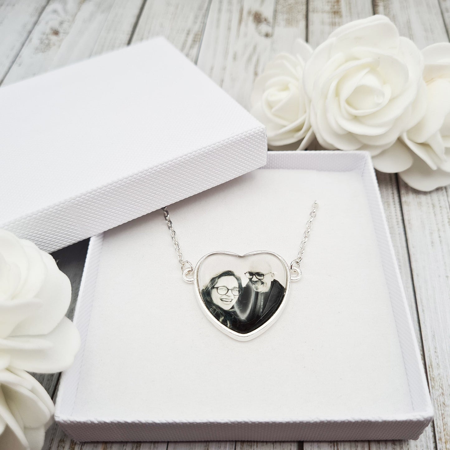 Heart shaped pendant personalised with a photo set in glass inside a white box