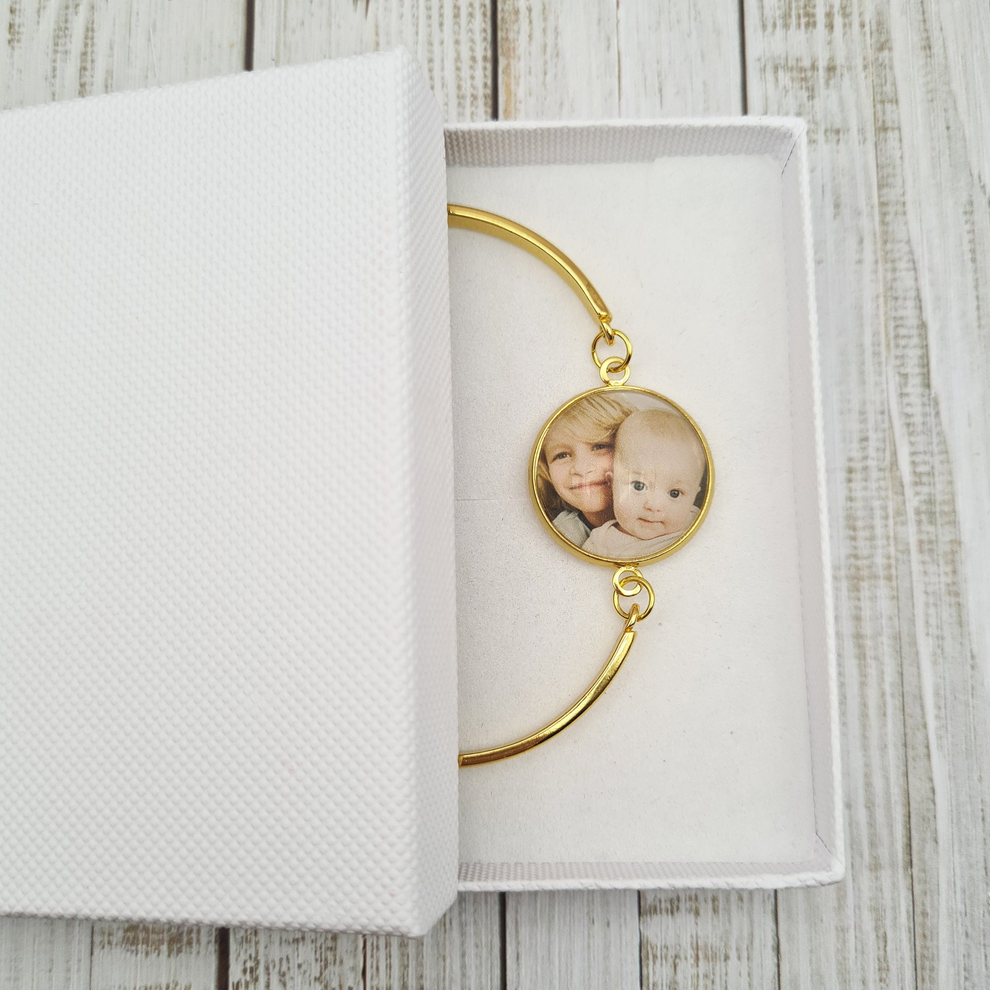 Gold bracelet personalised with a photo set in glass in a white gift box