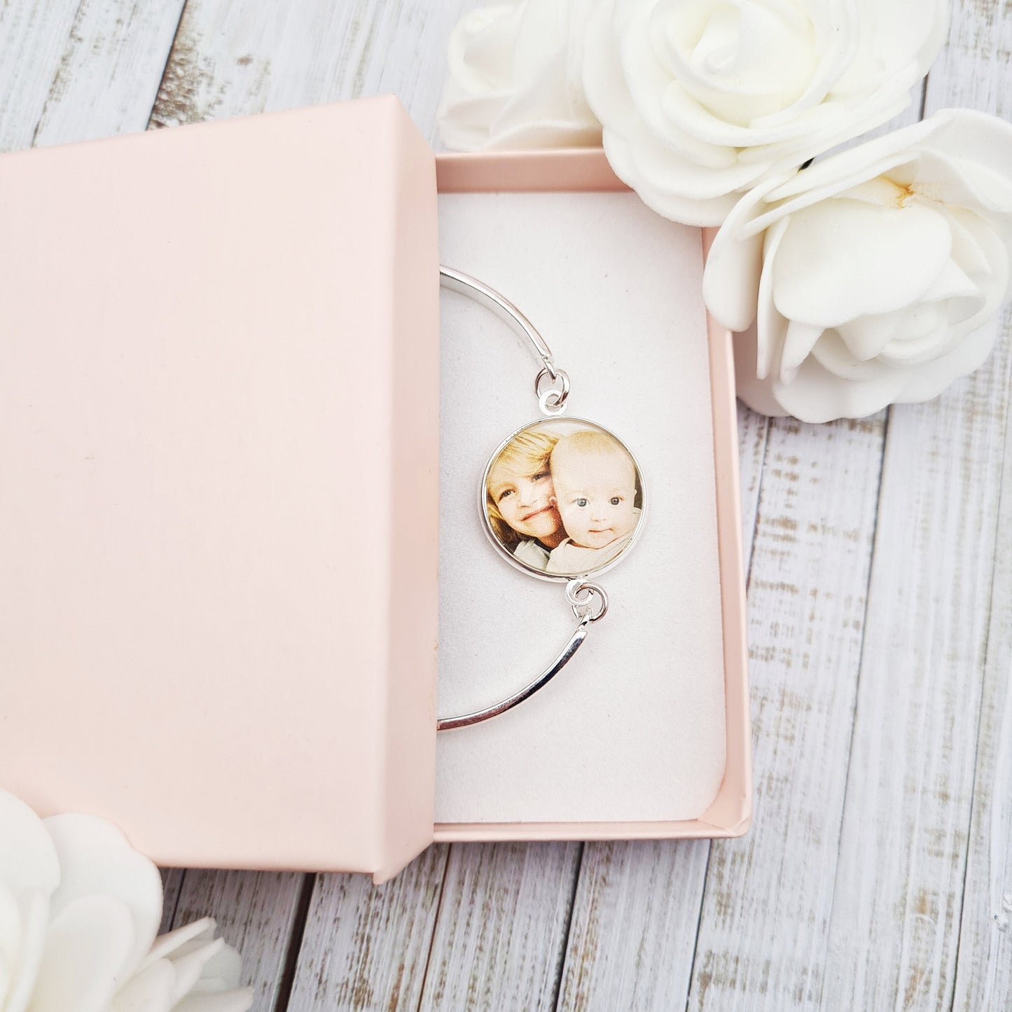 Silver bracelet with personalised photo set in glass inside a pink gift box