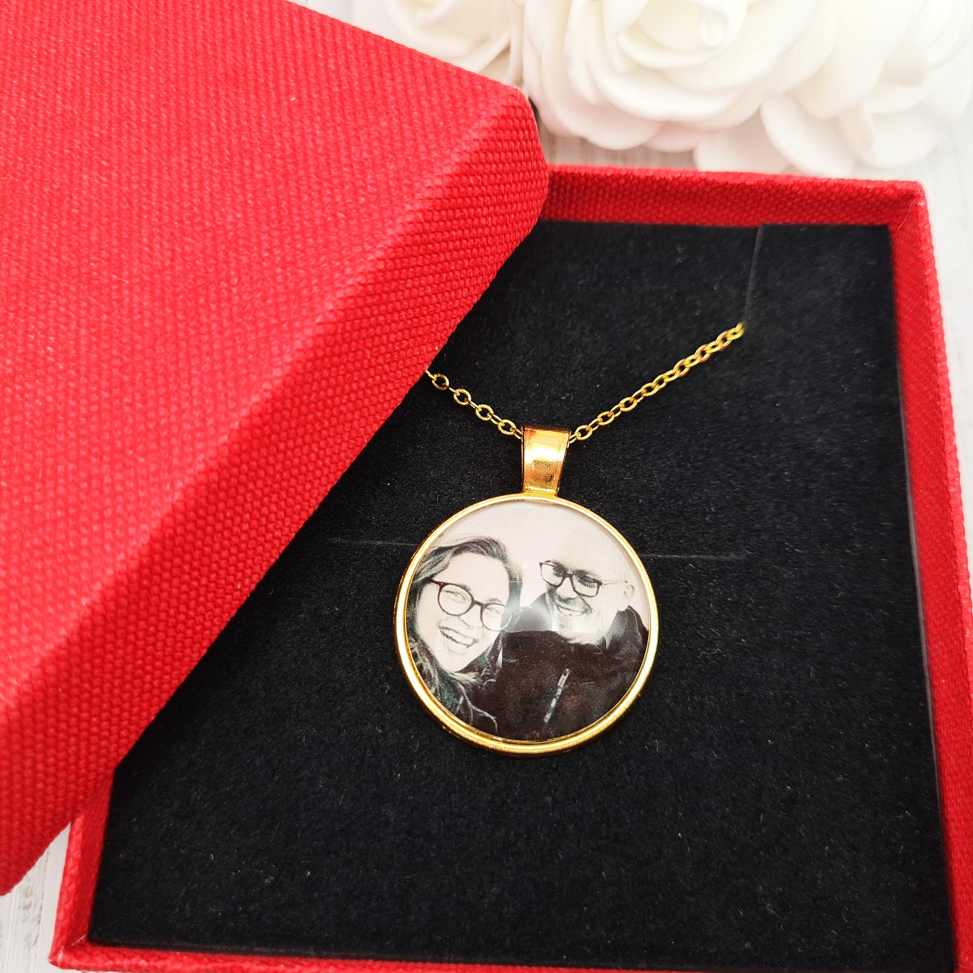 Gold necklace and pendant personalised with a photo set in glass inside a red box