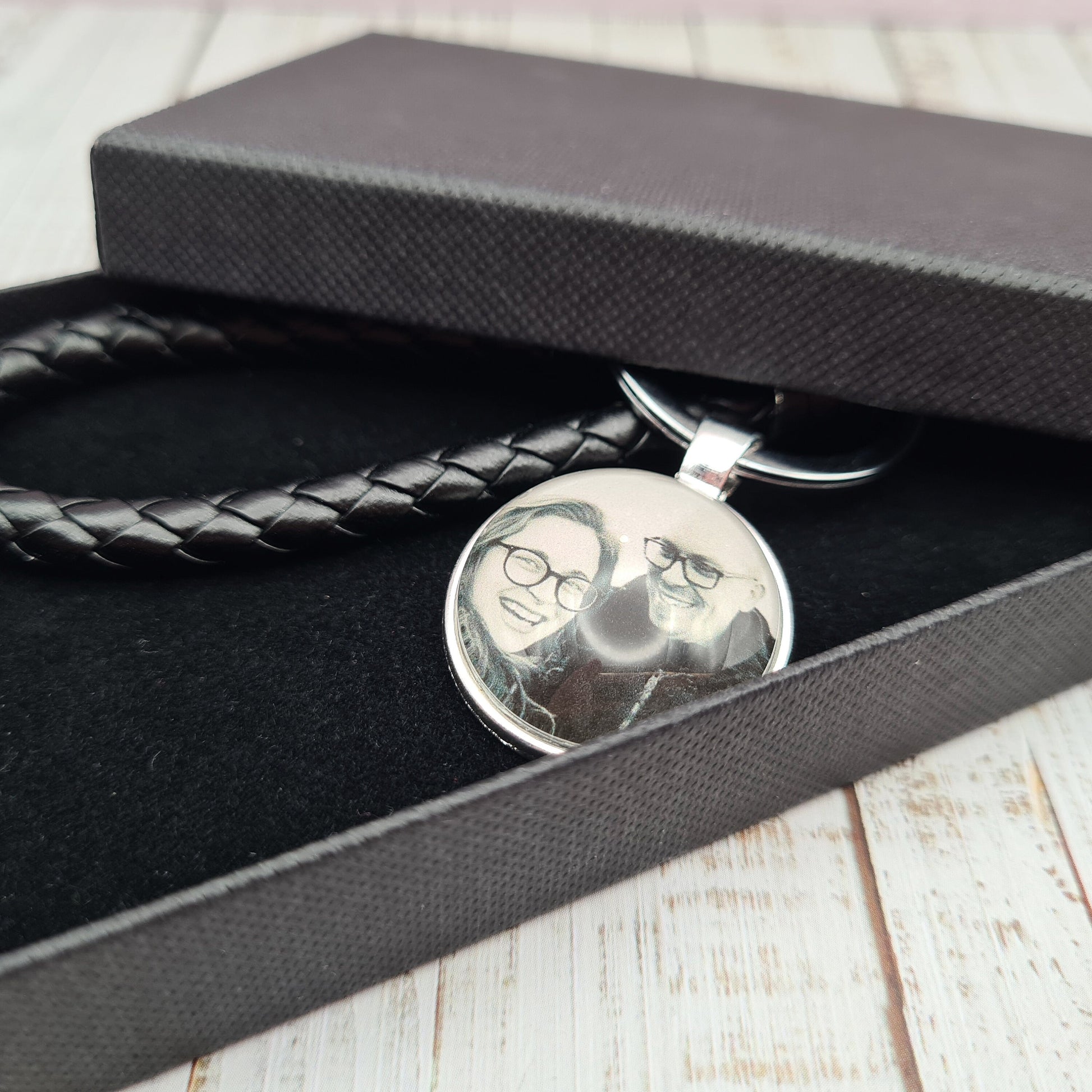 Black leather keyring with silver pendant and a personalised photo in glass inside a black box