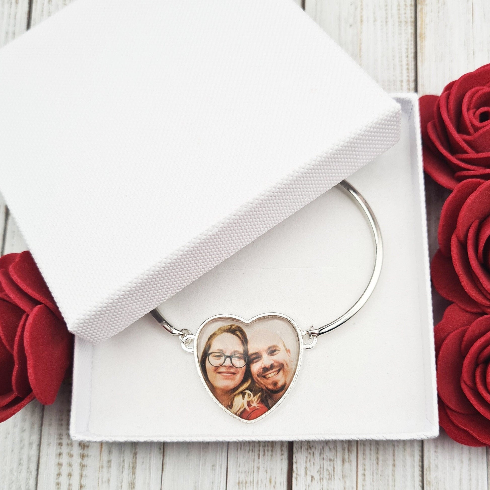 Silver heart shaped bracelet personalised with a photo set in glass inside a white gift box