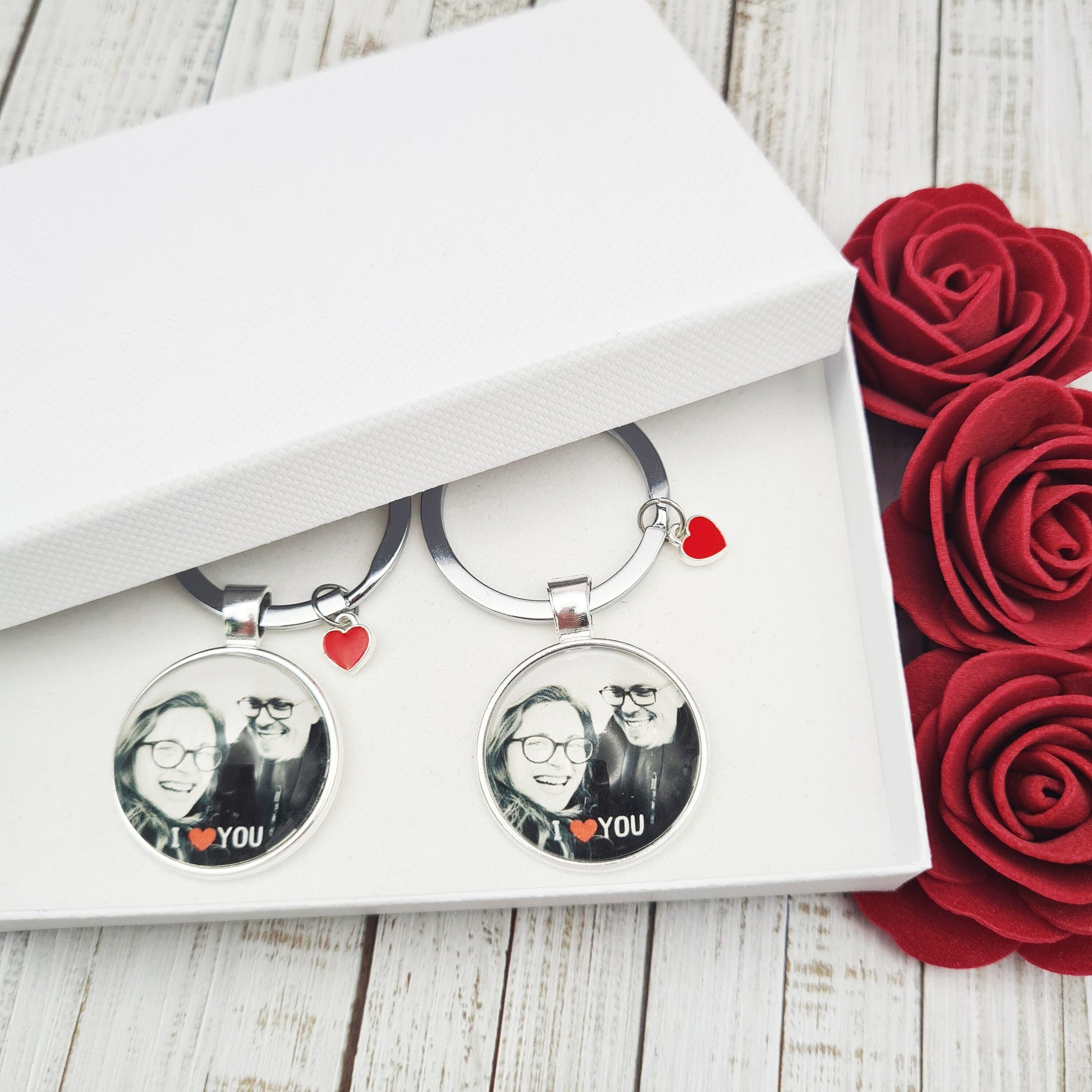 Set of two silver key rings with heart charms personalised with photos set in glass inside a white box