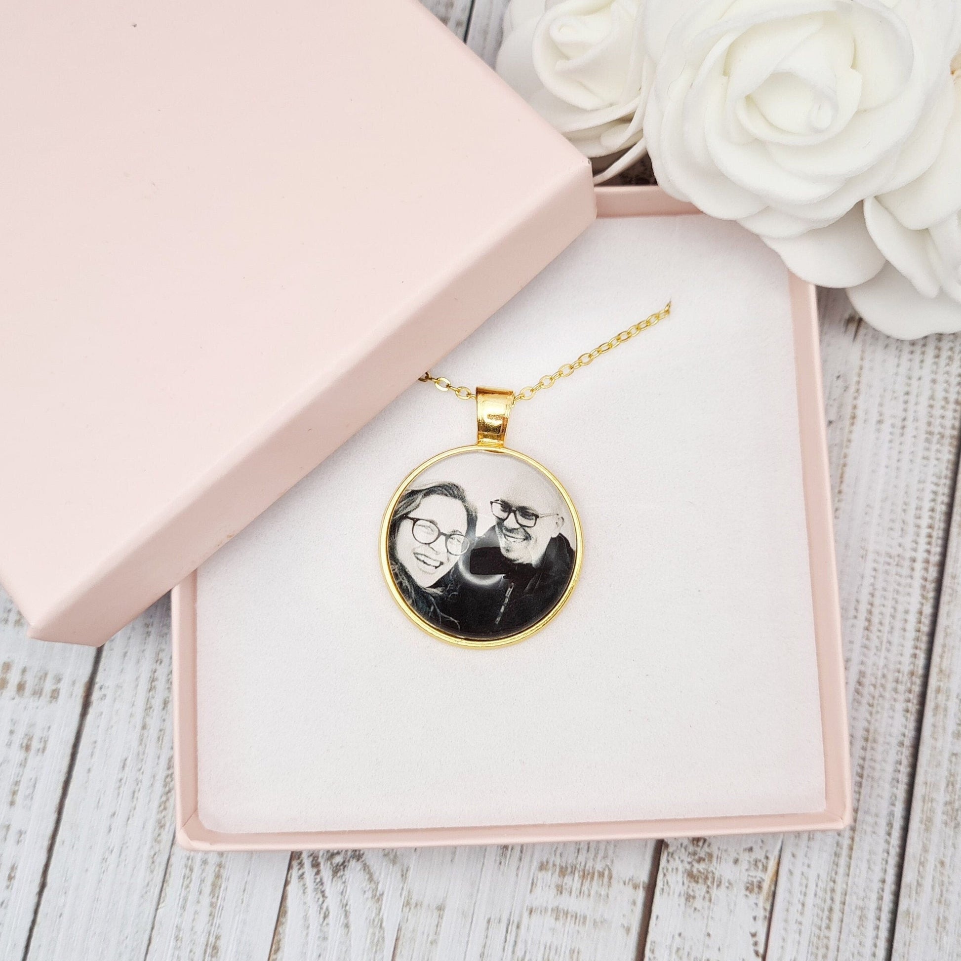 Gold necklace and pendant personalised with a photo set in glass inside a pink box