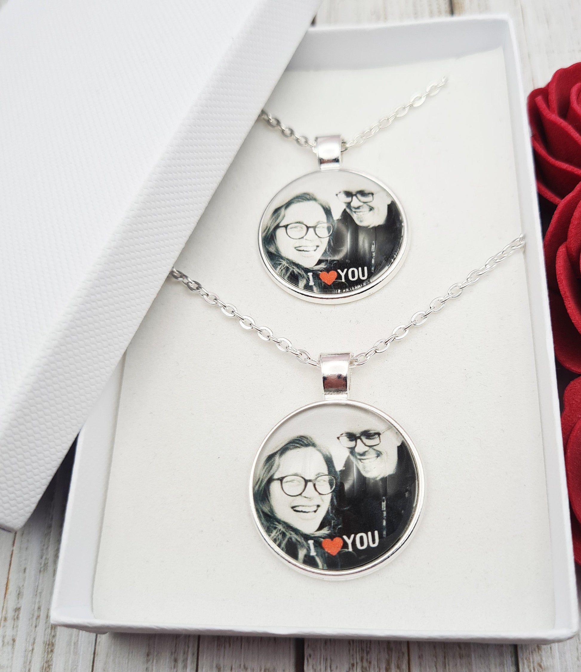 Couples duo silver necklaces personalised with photos set in glass inside a white gift box