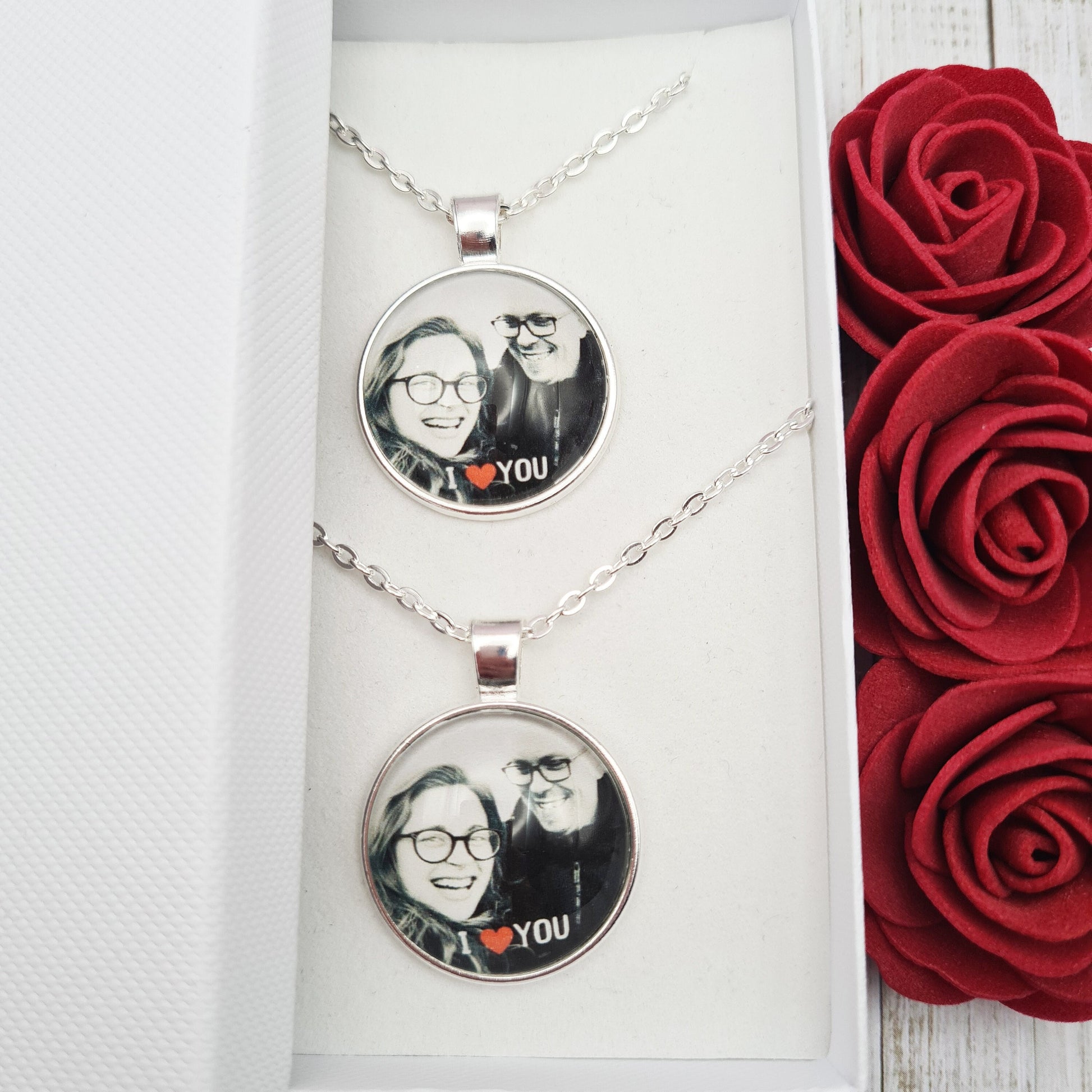 Couples duo silver necklaces personalised with photos set in glass inside a white gift box