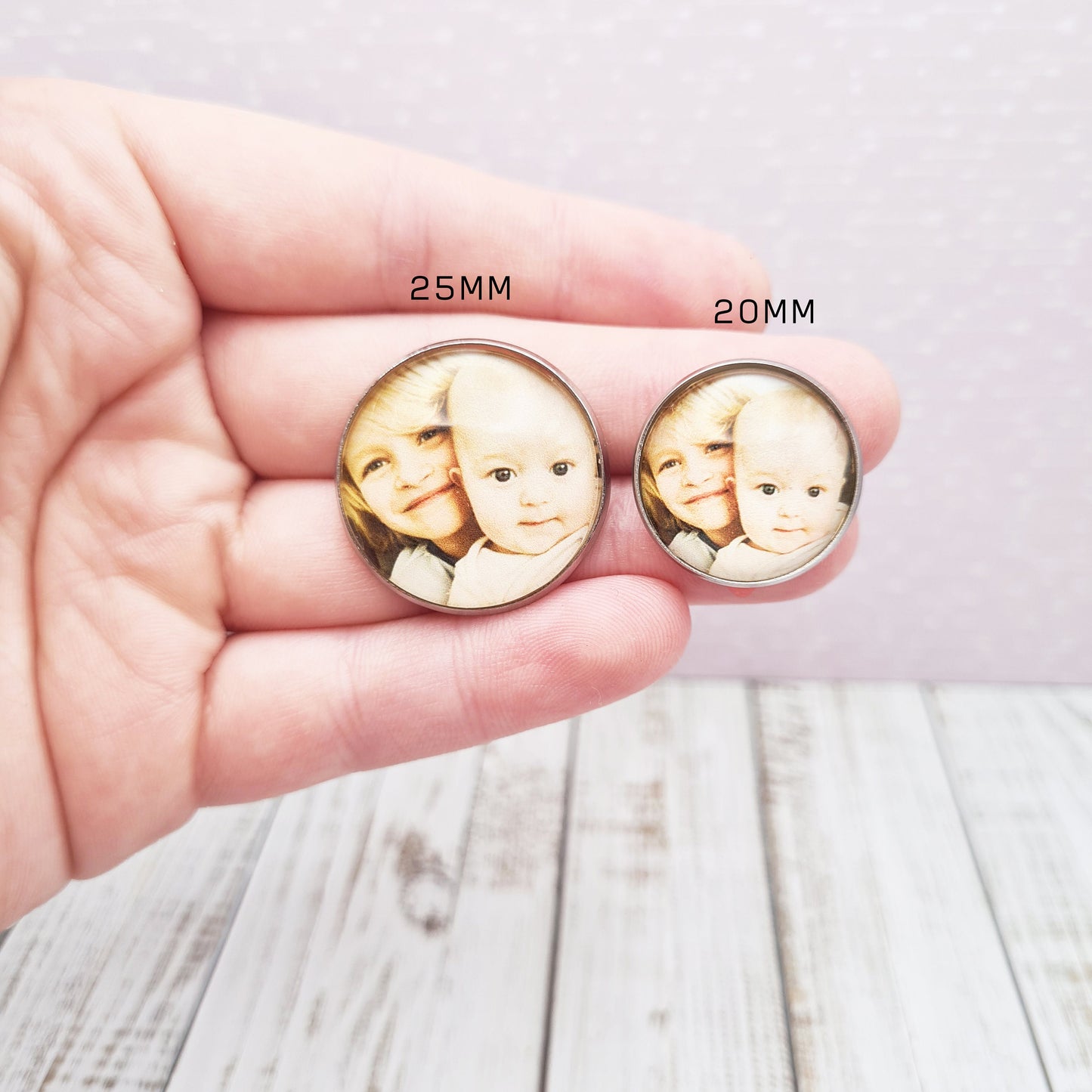 2 sizes of lapel pin with personalised photos held in-between fingers