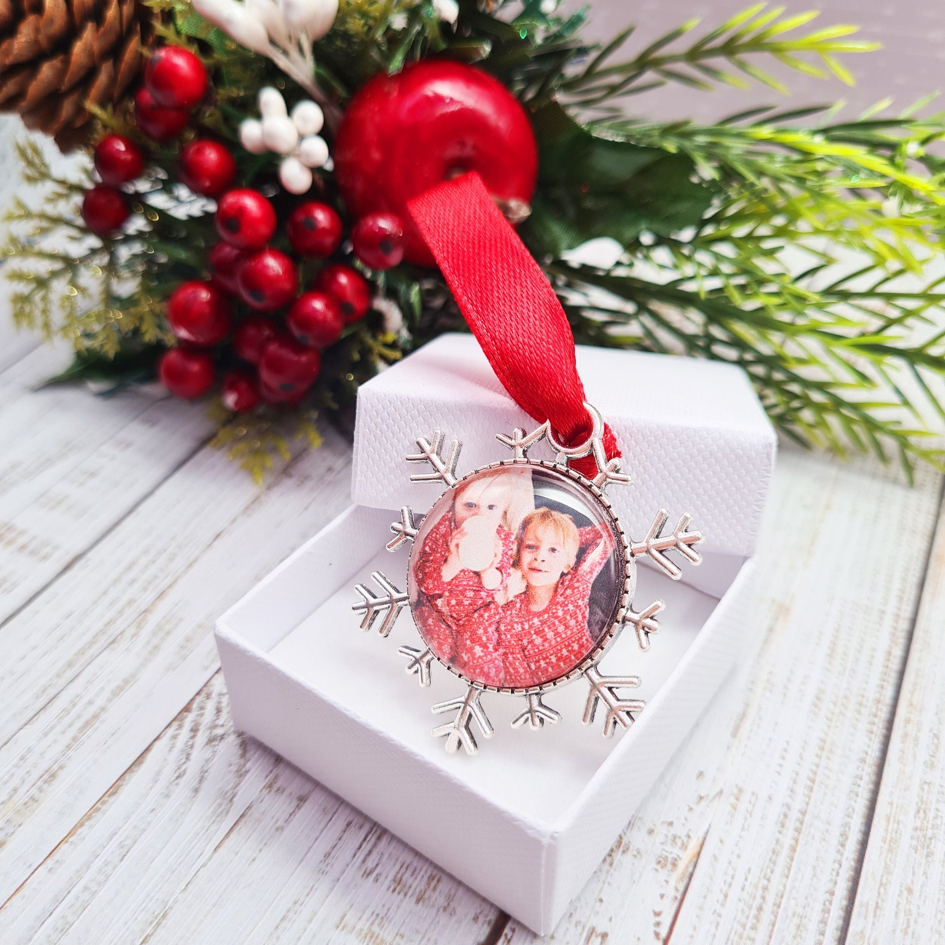 Christmas ornament personalised with photo with red ribbon in decorative box
