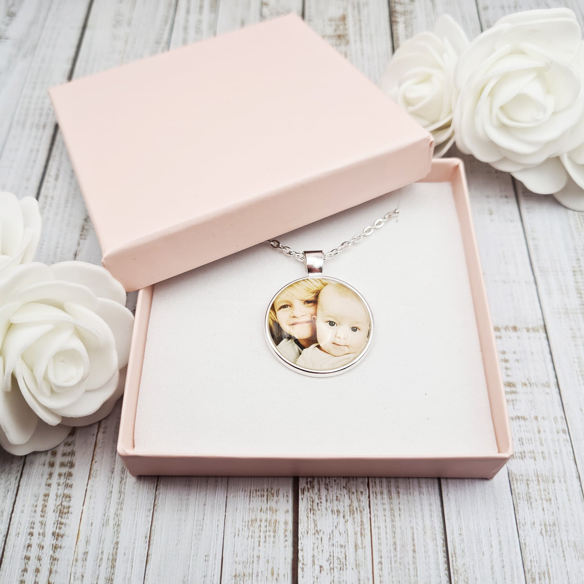 Silver necklace and pendant with personalised photo set in glass inside a pink gift box